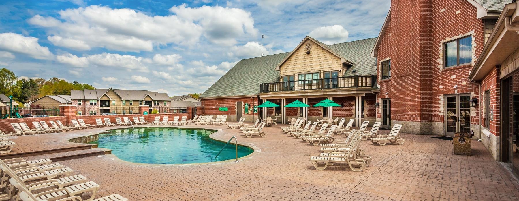 a pool in a brick courtyard