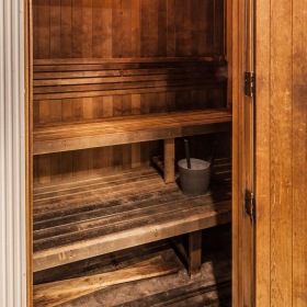a sauna with wood benches and a wood door