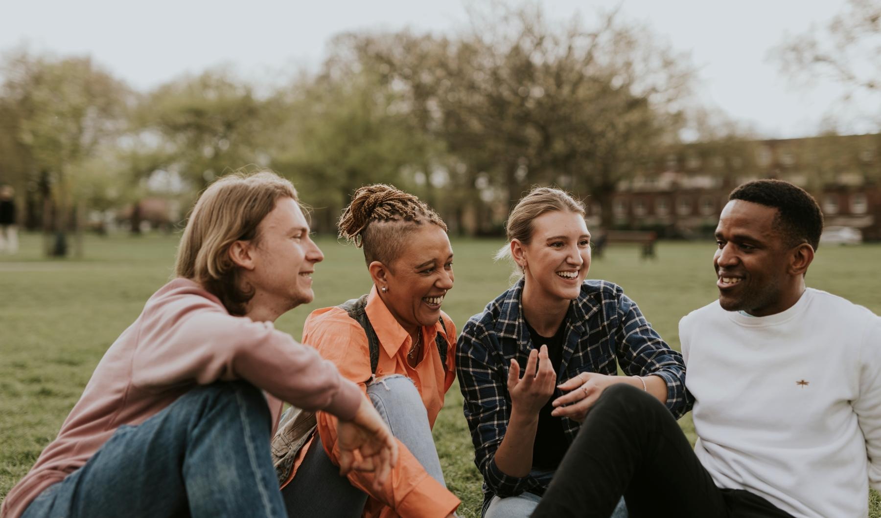a group of people sitting together smiling