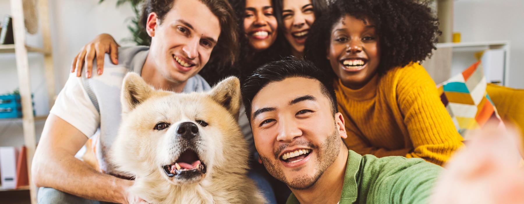 a group of people posing for a photo with a dog