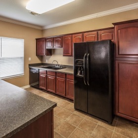 a kitchen with wooden cabinets