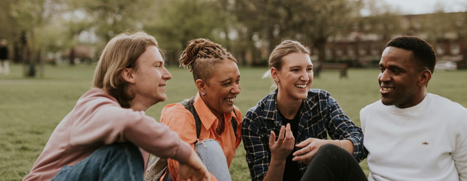 a group of people sitting together smiling